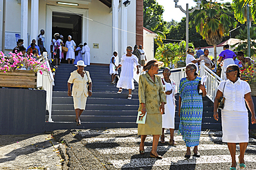 People outside the church after the Sunday mass in the village of Deshaies, Basse-terre, Guadeloupe, overseas region of France,Leewards Islands, Lesser Antilles, Caribbean