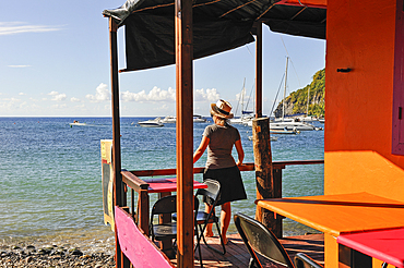 Cafe restaurant terrace on stilts, village of Deshaies, Basse-terre, Guadeloupe, overseas region of France,Leewards Islands, Lesser Antilles, Caribbean