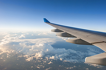 In-flight airliner wing seen through the window