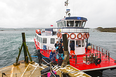Passengers disembarking from Travel Trident ferry boat at Roziere Steps on Herm Island, Bailiwick of Guernsey, United Kingdom