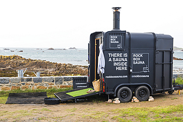 Mobile sauna (rockboxsauna.com) placed in the Cobo Bay on the west coast of Guernsey Island, Bailiwick of Guernsey, United Kingdom