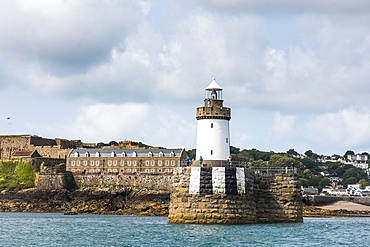 Castle Breakwater Lighthouse and Castle Cornet in the background, St Peter Port harbour, Guernsey Island, Bailiwick of Guernsey, United Kingdom