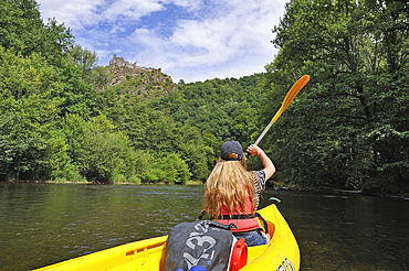 Canoeing on the Sioule River with the ruins of Chateau-Rocher in the background, Puy-de-Dome department, Auvergne-Rhone-Alpes region, France, Europe