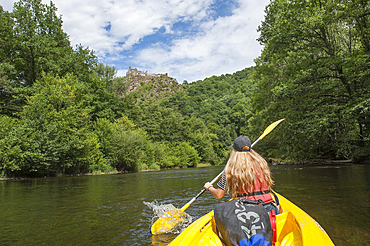 Canoeing on the Sioule River with the ruins of Chateau-Rocher in the background, Puy-de-Dome department, Auvergne-Rhone-Alpes region, France, Europe