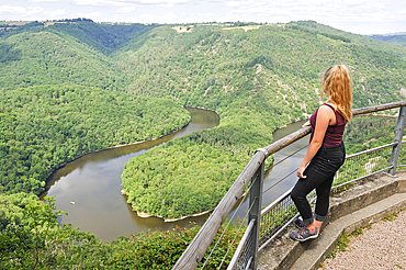 Young girl admiring the Queuille's meander (Meandre de Queuille) of the Sioule River from the 'Paradis' viewpoint, Puy-de-Dome department, Auvergne-Rhone-Alpes region, France, Europe
