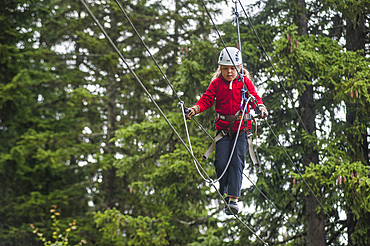 Young girl on a rope bridge at La Rosiere, ski resort in the territory of the commune of Montvalezan,Savoie department, Rhone-Alpes region, France, Europe