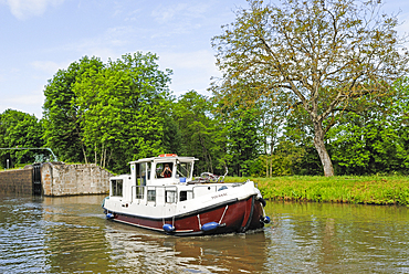 Houseboat approaching a lock of Canal du Centre around Chagny,Saone-et-Loire department,Burgundy region,France,Europe