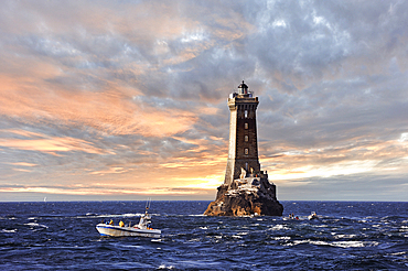 Sea bass fishing boat beside the lighthouse of La Vieille,Pointe du Raz, Cap Sizun,Finistere department,Brittany region,west of France,western Europe