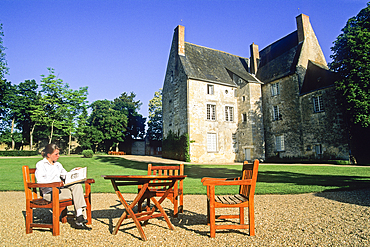 Young woman reading in the garden of Chateau de Sache, where the French writer Honore de Balzac wrote (between 1825 and 1848) some of his finest works in the series La Comedie Humaine, Indre-et-Loire department, Centre region, France, Europe