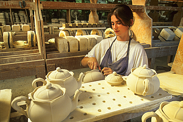 Skilled worker deburring some pieces,earthenware factory of Niderviller,Moselle department,Lorraine region,France,Europe