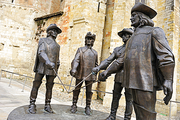 Monumental statue of The Three Musketeers and d'Artagnan (sculptor: Zurab Tsereteli) at the foot of the Saint-Pierre Cathedral,Condom,Gers department, Occitanie region, southwest of France,Europe