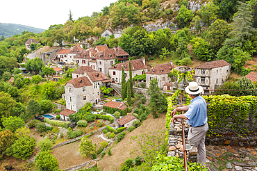 Man watching the landscape from the terraced gardens of the Chateau de la Gardette housing the Rignault Museum, Saint-Cirq-Lapopie, one of the ' Plus Beaux Villages de France' (the most beautiful villages of France), Lot department, region of Midi-Pyrenee