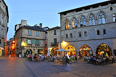 Outside restaurant at the foot of the Maison des Templiers (Knights Templar's House) on Champollion square at dusk, city of Figeac, Lot department, region of Midi-Pyrenees, Occitanie, southwest of France, Europe
