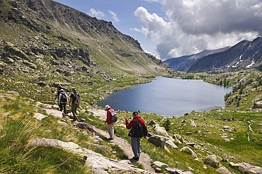 Hikers by the Long superieur Lake,Vallee des Merveilles, Mercantour National Park, Alpes-Maritimes department, Provence-Alpes-Cote d'Azur region,southeast of France,Europe.