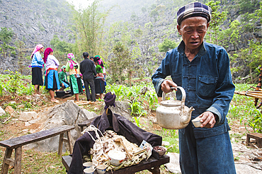 Shaman doing rituals above altar in memory of deceased,funeral in a village around Sa Phin, Ha Giang province, Northern Vietnam, Southeast Asia