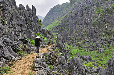 Man walking along a mountain path around Sa Phin, Ha Giang province, Northern Vietnam, Southeast Asia