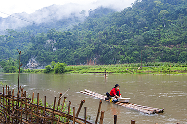 Woman doing washing on the lakeshore, Ba Be Lake, Bac Kan province, Northern Vietnam, Southeast Asia