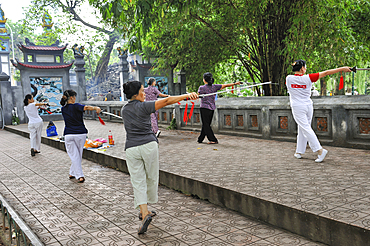 Women practising Tai Chi with sword, Ngoc Son Temple on the edge of Hoan Kiem Lake, Hanoi, Northern Vietnam, Southeast Asia