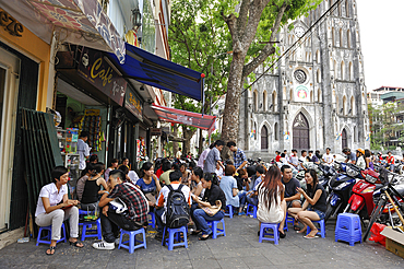 Young people on the café terrace in front of St Joseph Cathedral, Hanoi, Northern Vietnam, Southeast asia