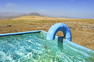 Watering place on the Argitchi plateau, Armaghan volcano in the background, Gegharkunik region, Armenia, Eurasia