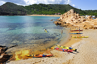 Kayaks landing on an islet in the inlet Cala Pregonda near Cape Cavalleria on the North Coast of Menorca, Balearic Islands, Spain, Mediterranean, Europe