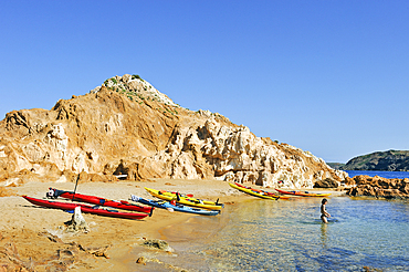 Kayaks landed on an islet in the inlet Cala Pregonda near Cape Cavalleria on the North Coast of Menorca, Balearic Islands, Spain, Mediterranean, Europe