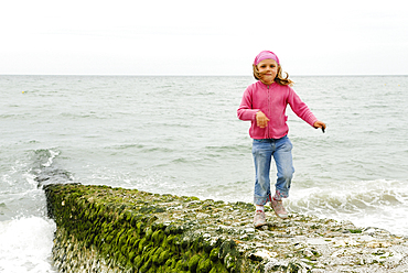 Little girl on the beach of Etretat, Cote d'Albatre, Pays de Caux, Seine-Maritime department, Upper Normandy region, France, Europe