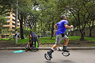 Man doing kangoo jumps training, Zona Rosa area, Bogota, Colombia, South America