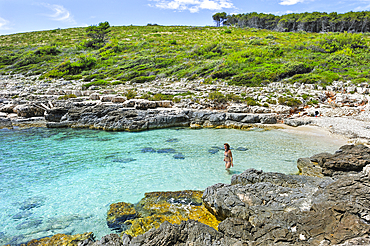 Woman swimming at the small beach of Perna inlet, Palmizana, St. Clement island, Hell's Islands (Pakleni), Hvar city, Hvar island, Croatia, Southeast Europe