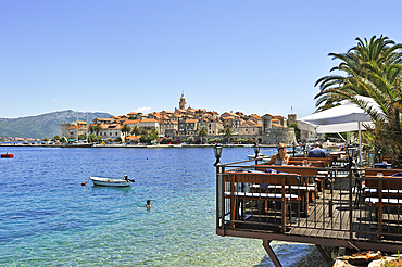 Cafe terrace on stilts, Bay of Korcula old town, Korcula island, Croatia, Southeast Europe