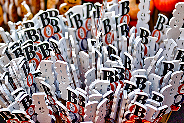 Close-up image of a cluster of white wooden sticks with black letters spelling \'BOO\' in a chaotic arrangement.