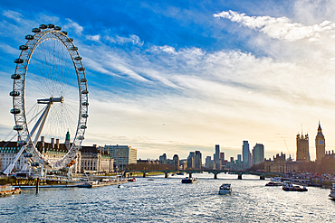 London's skyline featuring the London Eye, river Thames, several boats, and the Houses of Parliament under a partly cloudy sky.