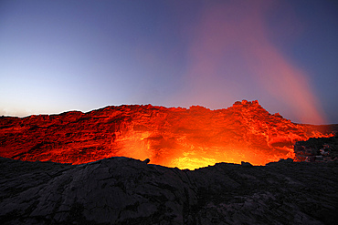 January 30, 2011 - Lava lake illuminating walls of pit crater at nightfall, Erta Ale volcano, Danakil Depression, Ethiopia.