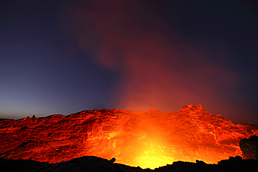 January 30, 2011 - Lava lake illuminating walls of pit crater at nightfall, Erta Ale volcano, Danakil Depression, Ethiopia.