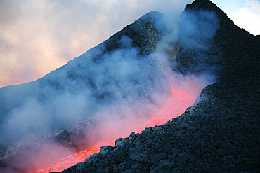 November 2006 - Lava flowing from base of hornito during eruption of Mount Etna volcano, Sicily, Italy.