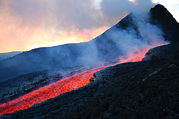 November 2006 - Lava flowing from base of hornito during eruption of Mount Etna volcano, Sicily, Italy.