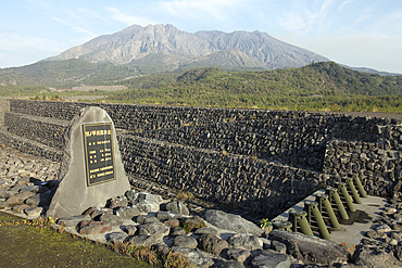 March 1, 2010 - Sabo channel at Haramatsu River with tubular grid dam (slit dam type), for defense and protection against mudflows, with Sakurajima volcano in background, Japan
