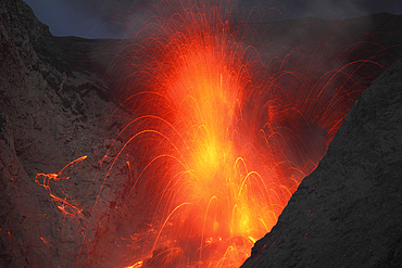 November 26, 2012 - Explosive strombolian type eruption of Batu Tara volcano, Komba Island, Indonesia. Trajectories of red glowing lava bombs are visible.