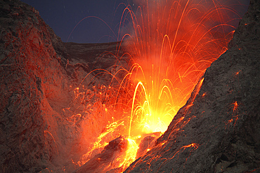 November 25, 2012 - Explosive strombolian type eruption of Batu Tara volcano, Komba Island, Indonesia. Trajectories of red glowing lava bombs are visible.