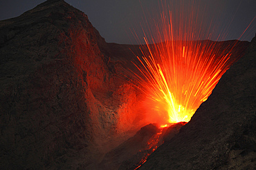 November 26, 2012 - Powerful explosive strombolian type eruption of Batu Tara volcano, Komba Island, Indonesia. Trajectories of red glowing lava bombs are visible.