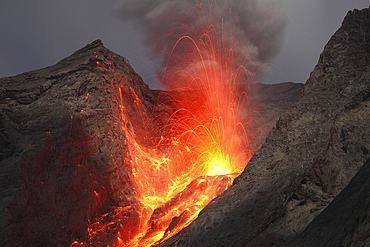 November 27, 2012 - Explosive strombolian type eruption of Batu Tara volcano, Komba Island, Indonesia. Trajectories of red glowing lava bombs are visible.