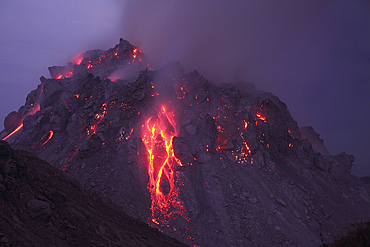 November 30, 2012 - Glowing Rerombola lava dome with incandescent rockfall deposit, Paluweh volcano, Flores, Indonesia.
