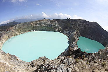 December 3, 2012 - Colourful crater lakes of Kelimutu volcano, Flores Island, Indonesia. Tiwu Nua Muri Koo Fai (Lake of Young Men and Maidens) and Tiwu Ata Polo (Bewitched Lake). The two lakes are highly acidic due to underwater fumarole activity and are turqoise in colour.