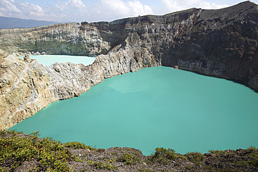 December 3, 2012 - Colourful crater lakes of Kelimutu volcano, Flores Island, Indonesia. Tiwu Nua Muri Kofah (Lake of Young Men and Maidens) and Tiwu Ata Polo (Bewitched Lake). The two lakes are highly acidic due to underwater fumarole activity and are turqoise in colour.