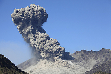 February 24, 2013 - Powerful explosive eruption of Sakurajima volcano, Japan. Ash cloud rises against blue sky.