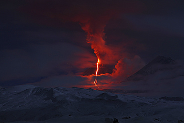 October 16, 2013 - Nighttime eruption of Kliuchevskoi (Klyuchevskoy) Volcano, Kamchatka, Russia. Ash cloud and lava flow are produced by the activity of the volcano which is partially shrouded in cloud. Kamen volcano is seen on right.