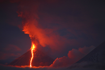 October 16, 2013 - Nighttime eruption of Kliuchevskoi (Klyuchevskoy) Volcano, Kamchatka, Russia.
Ash cloud and lava flow are produced by the activity of the snowcovered conical stratovolcano.