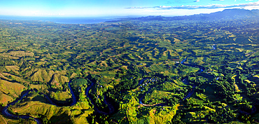 The Nadi River winds through the valleys, forests and villages with the Sleeping Giant mountains and Nadi coastal town in the background as seen from 2000 feet high on an Adrenalin Fiji balloon.