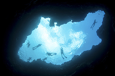 Snorkelers swim above a blue hole on Palau's barrier reef. This hole formed when sea level was much lower than it is today.