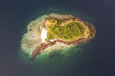 A bird's eye view of an idyllic island and healthy fringing reef in Komodo National Park, Indonesia. This tropical area in the Lesser Sunda Islands is known for its marine biodiversity as well as its infamous Komodo dragons.